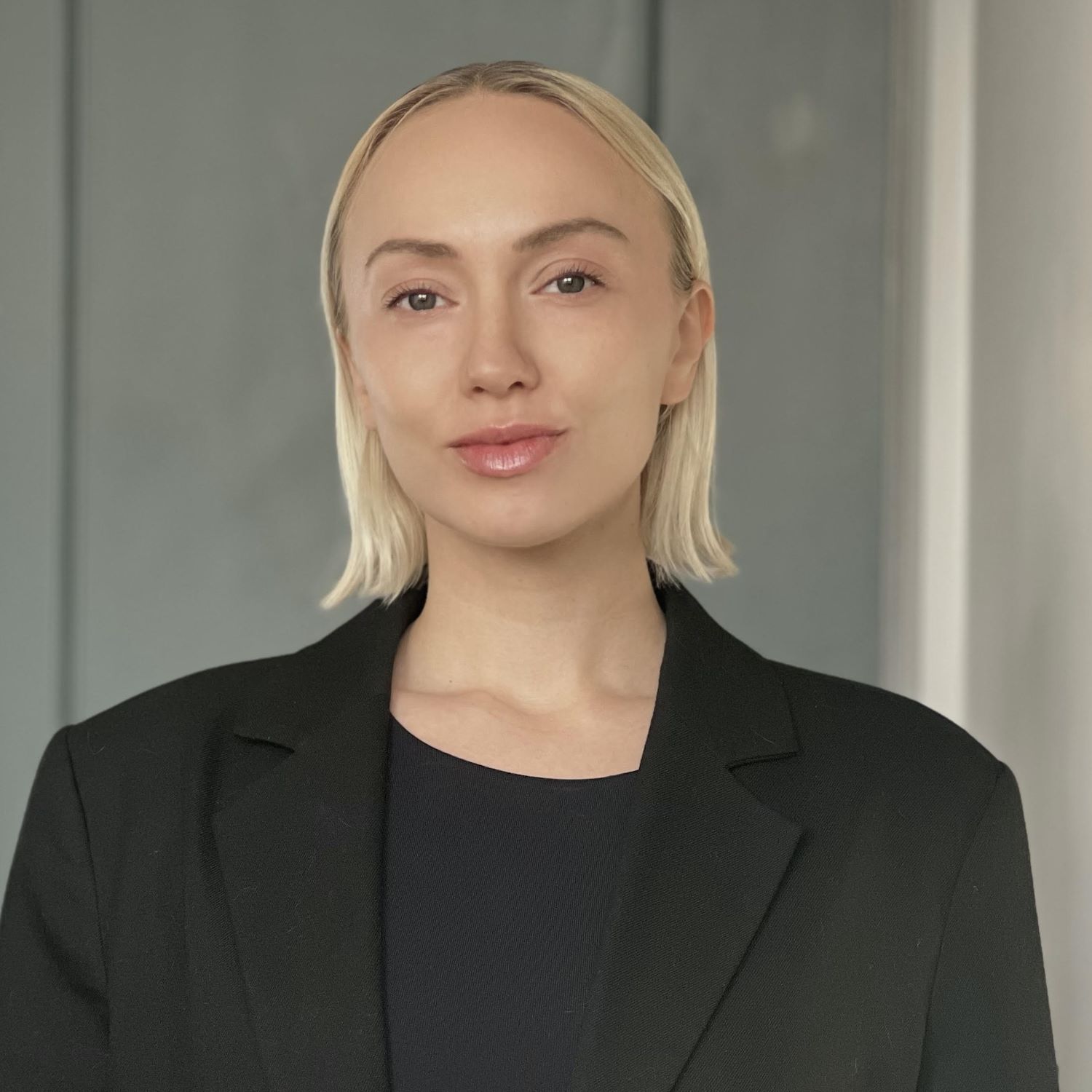 Christina K Photo of Christina Kapanen; blonde woman wearing black shirt and blazer